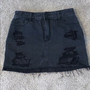 Distressed black jean skirt